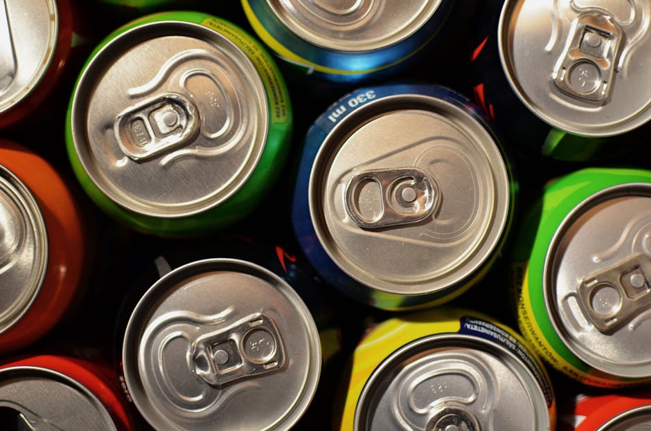 Close-up of colorful beverage cans arranged closely together, showcasing various colors.